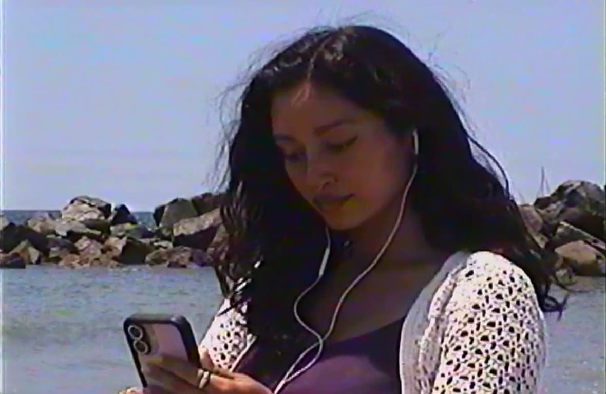 christa guzmán listening to music by the water
