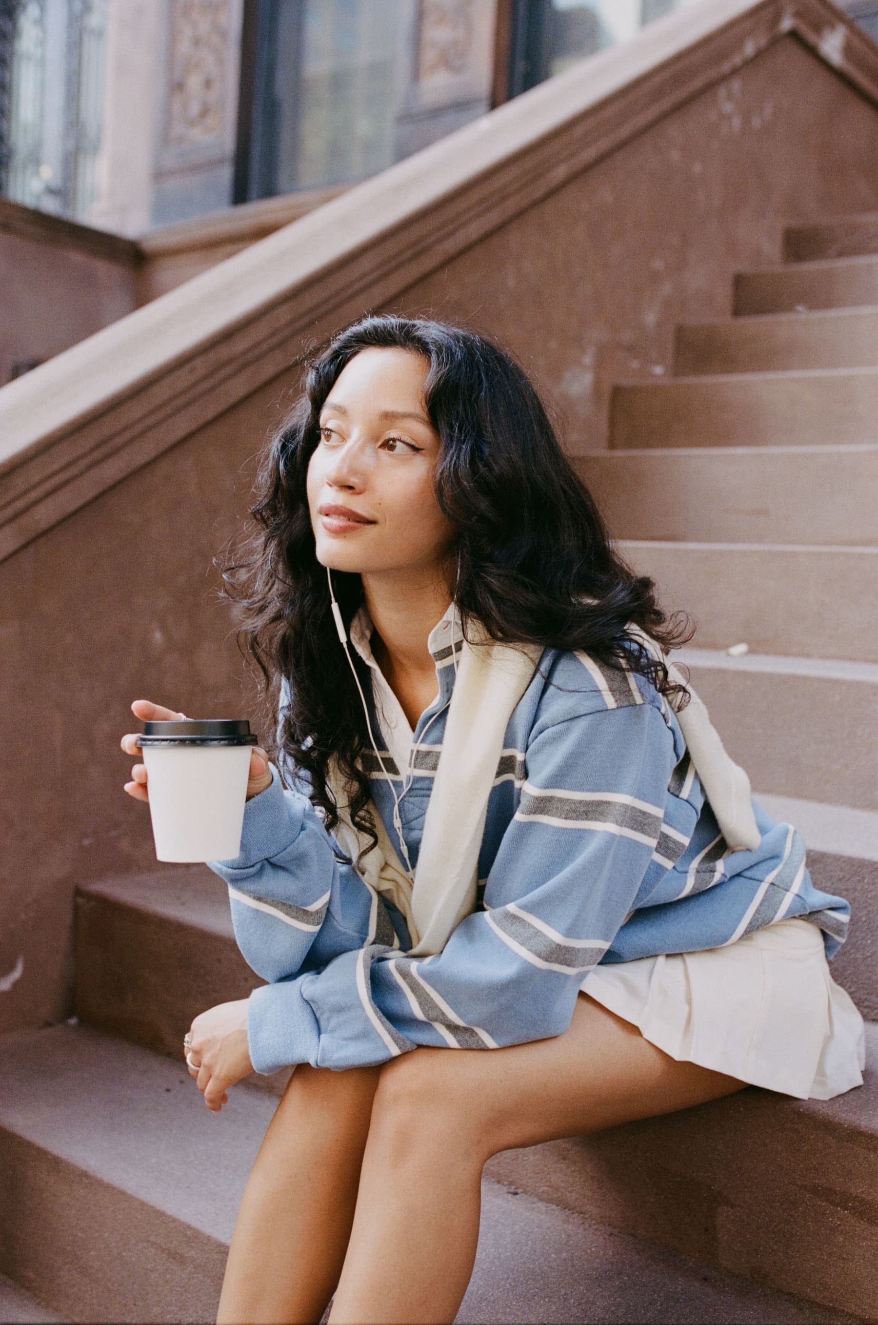christa guzmán seated on brownstone steps in nyc